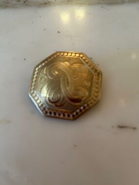 Octagonal Gold-Tone Decorative Brooch w/ fluid detail.